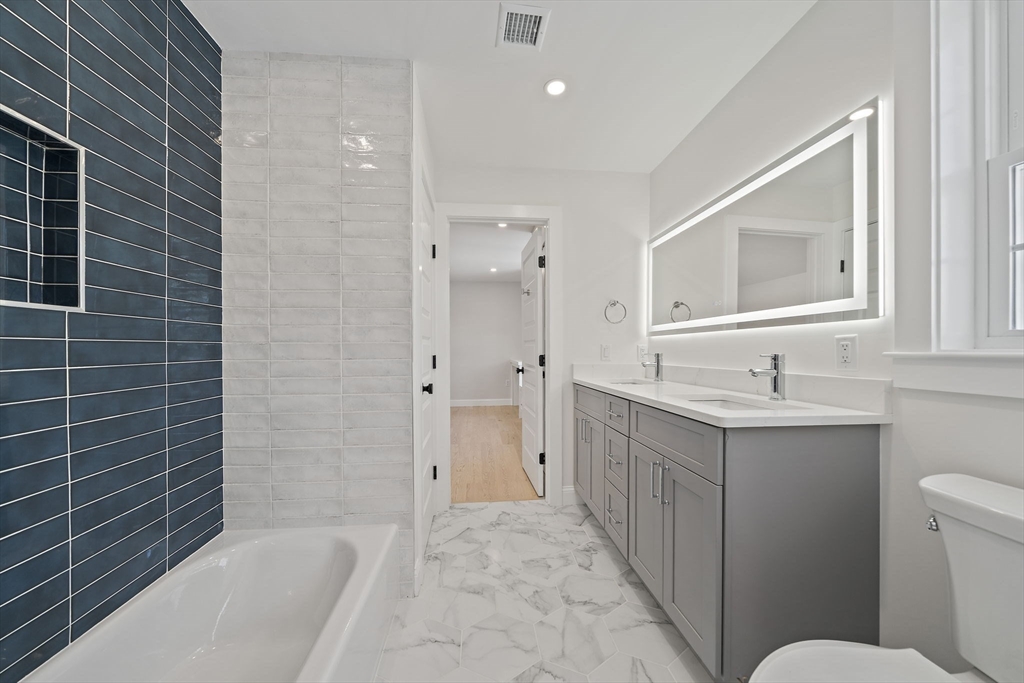 250 Center Street Hanover, MA 02339 - Photo 27 of 36 a bathroom with a sink a toilet and shower