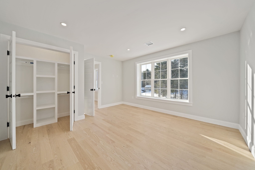 250 Center Street Hanover, MA 02339 - Photo 29 of 36 an empty room with wooden floor closet and windows