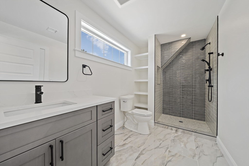 250 Center Street Hanover, MA 02339 - Photo 30 of 36 a bathroom with a sink a toilet and shower