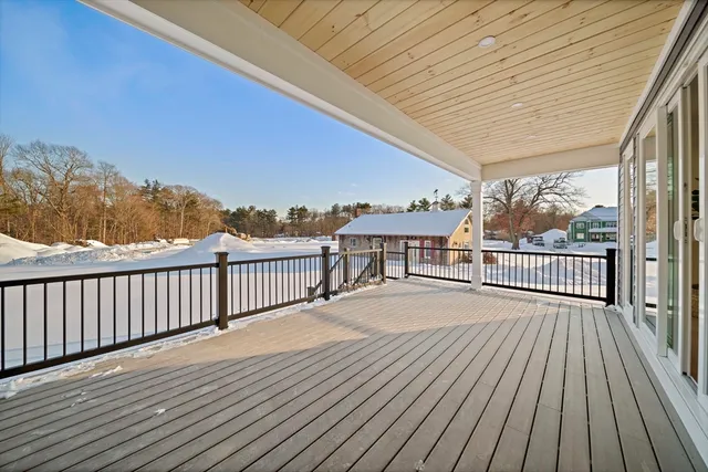 a balcony with wooden floor and fence