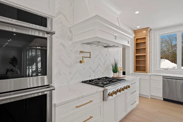 a kitchen with stainless steel appliances granite countertop a stove and a sink