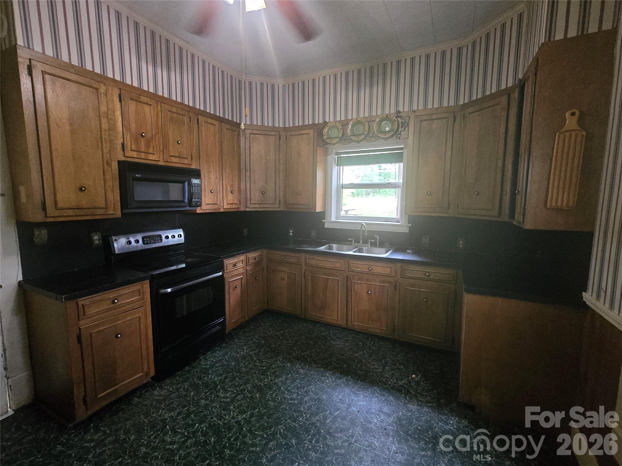 804 Emmanuel Church Road Conover, NC 28613 - Photo 17 of 36 a kitchen with granite countertop a stove a sink and a microwave
