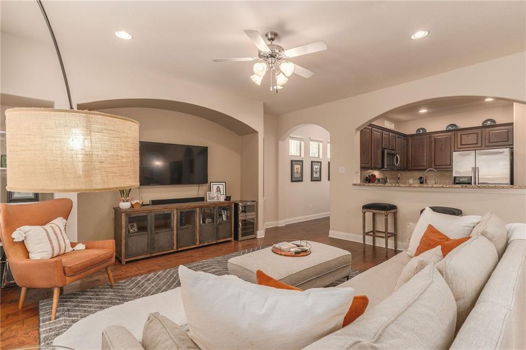 6708 Menchaca Road, Unit 14 Austin, TX 78745 - Photo 16 of 22 Open-concept living area with wood-finish flooring, a ceiling fan with integrated lighting, recessed lighting, and arched doorways