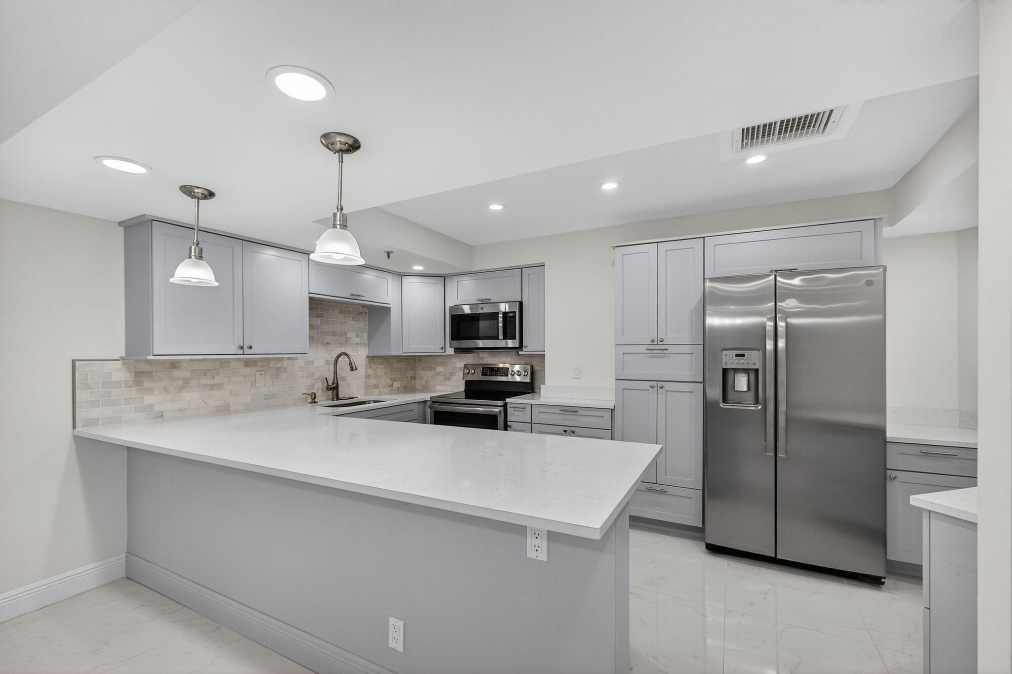 176 Helios Drive, Unit 209 Jupiter, FL 33477 - Photo 13 of 62 a kitchen with refrigerator and a sink