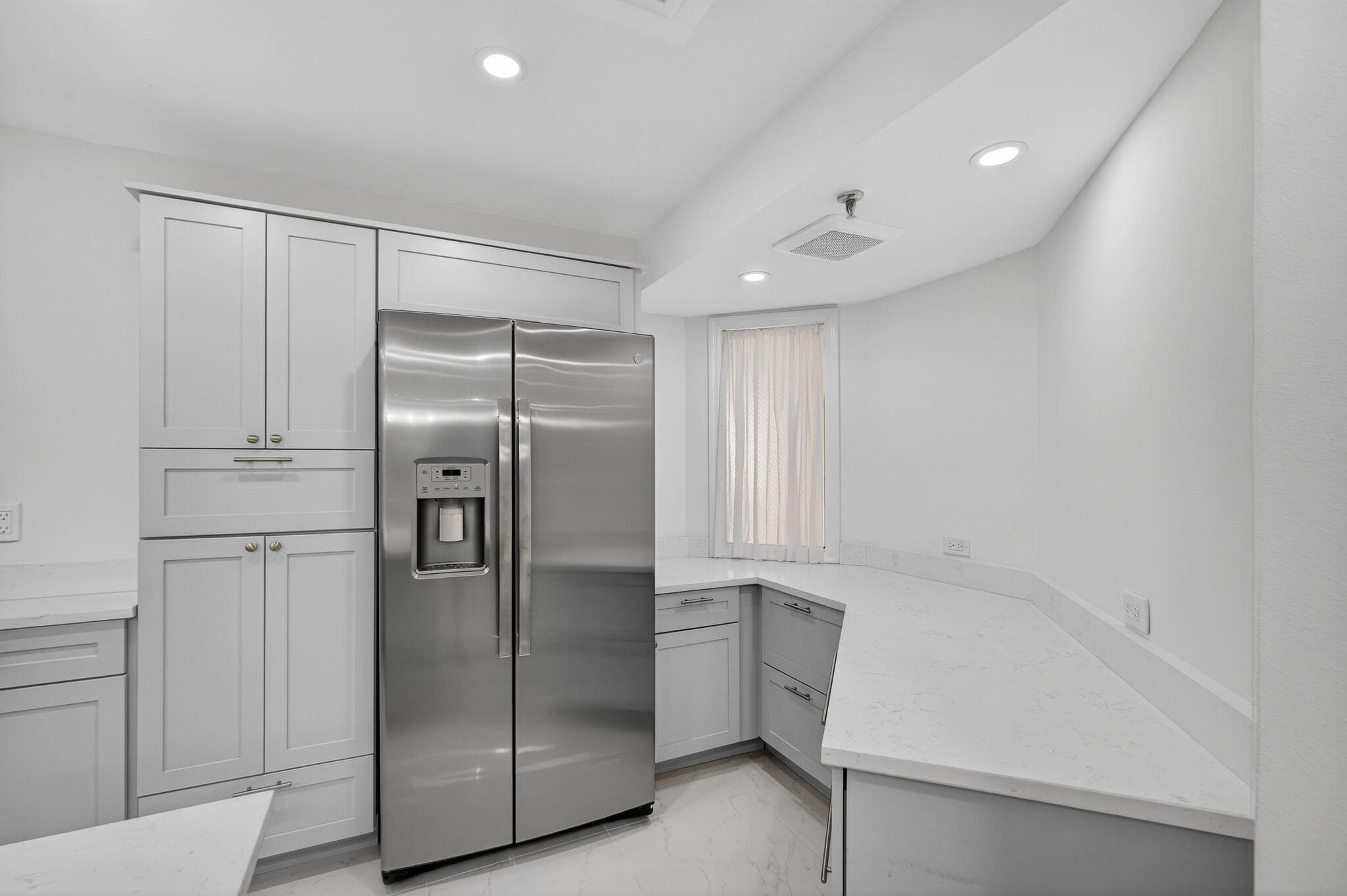176 Helios Drive, Unit 209 Jupiter, FL 33477 - Photo 15 of 62 a kitchen with white cabinets and stainless steel appliances