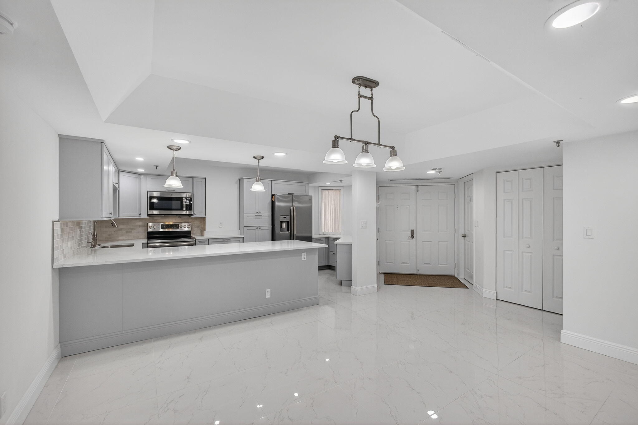 176 Helios Drive, Unit 209 Jupiter, FL 33477 - Photo 17 of 62 a view of a kitchen with a sink stainless steel appliances and cabinets