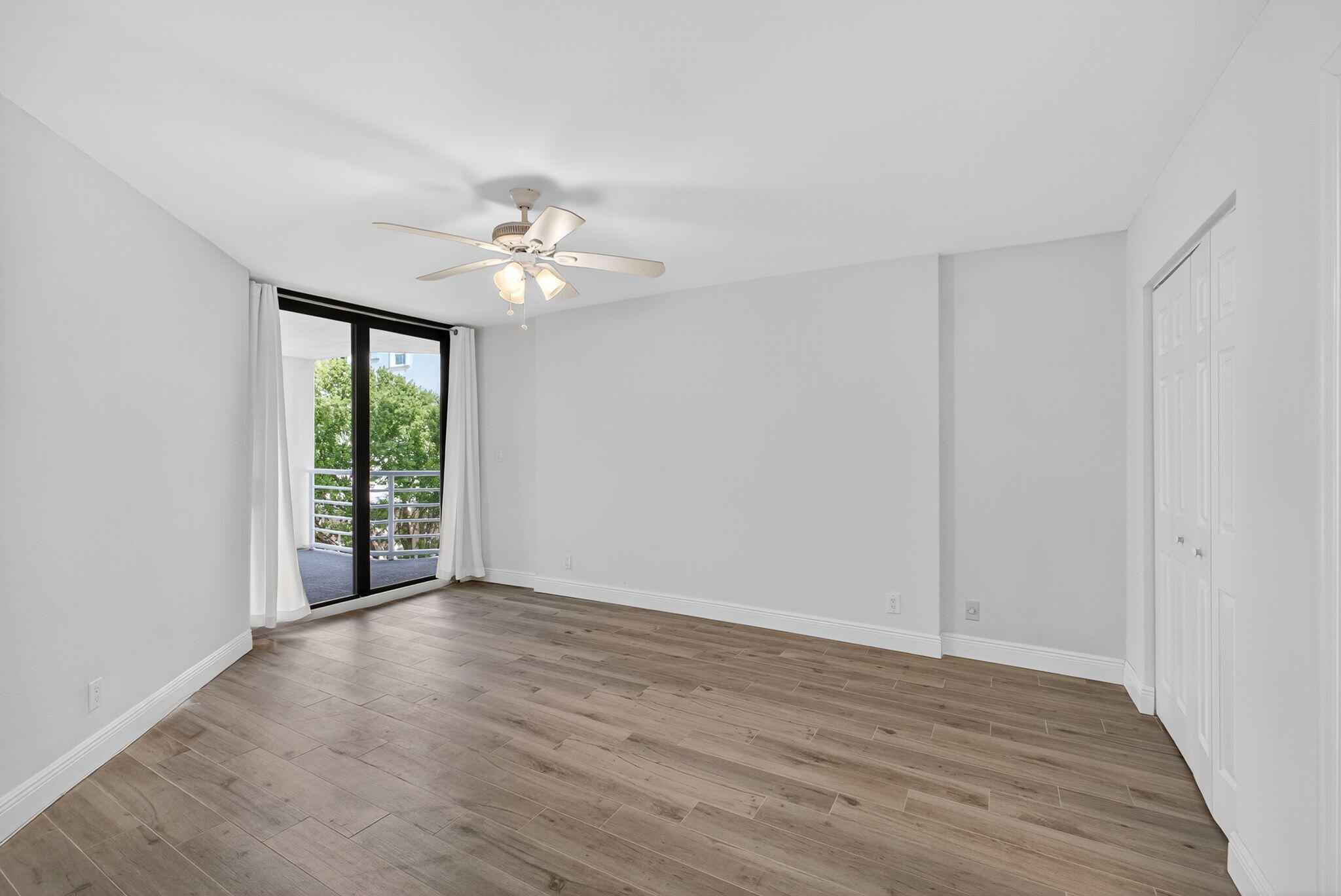 176 Helios Drive, Unit 209 Jupiter, FL 33477 - Photo 28 of 62 wooden floor in an empty room with a window