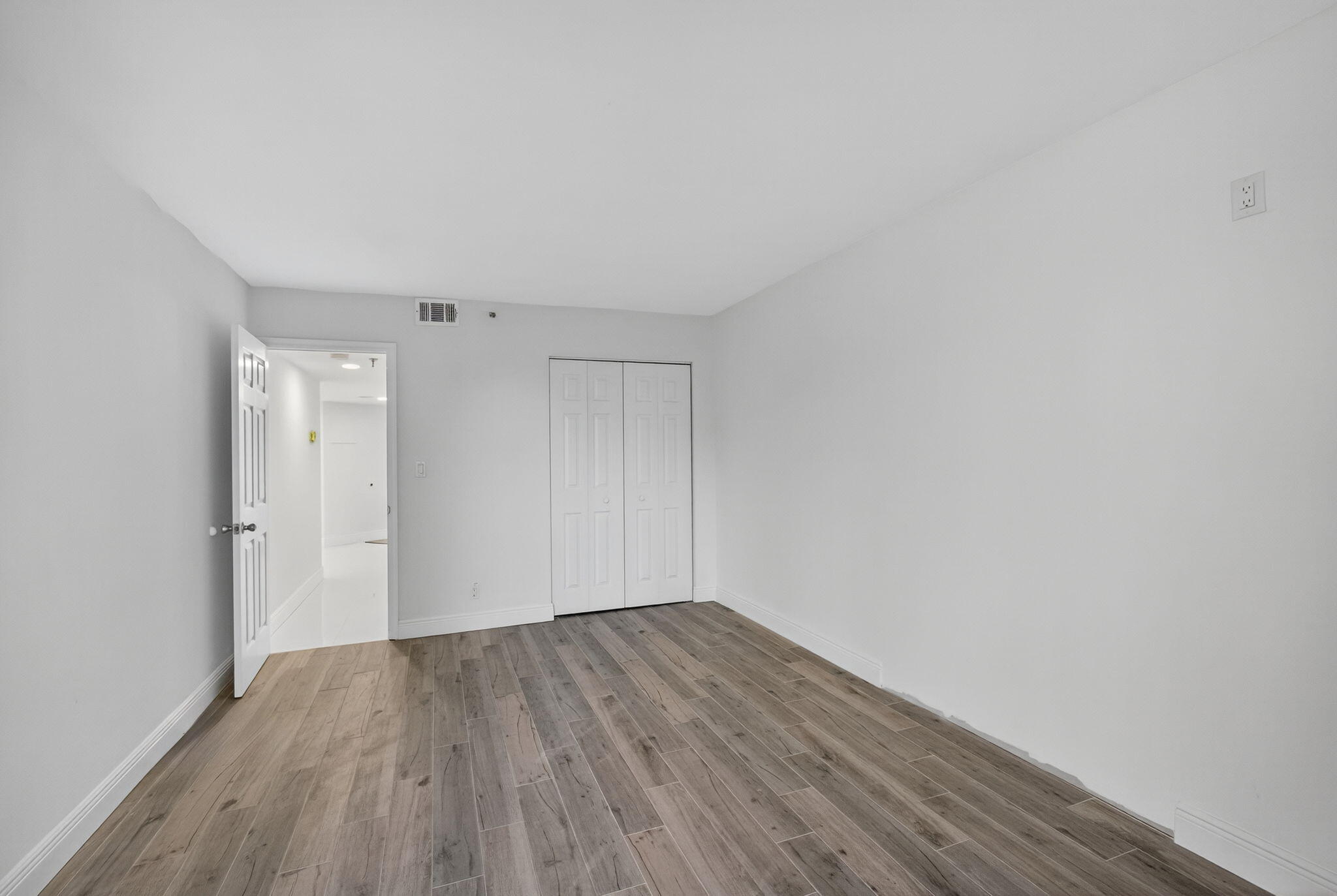 176 Helios Drive, Unit 209 Jupiter, FL 33477 - Photo 29 of 62 a view of a room with wooden floor