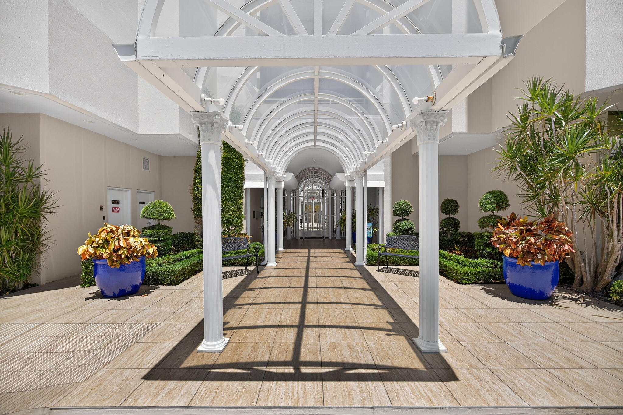 176 Helios Drive, Unit 209 Jupiter, FL 33477 - Photo 52 of 62 a porch with seating space and a potted plant