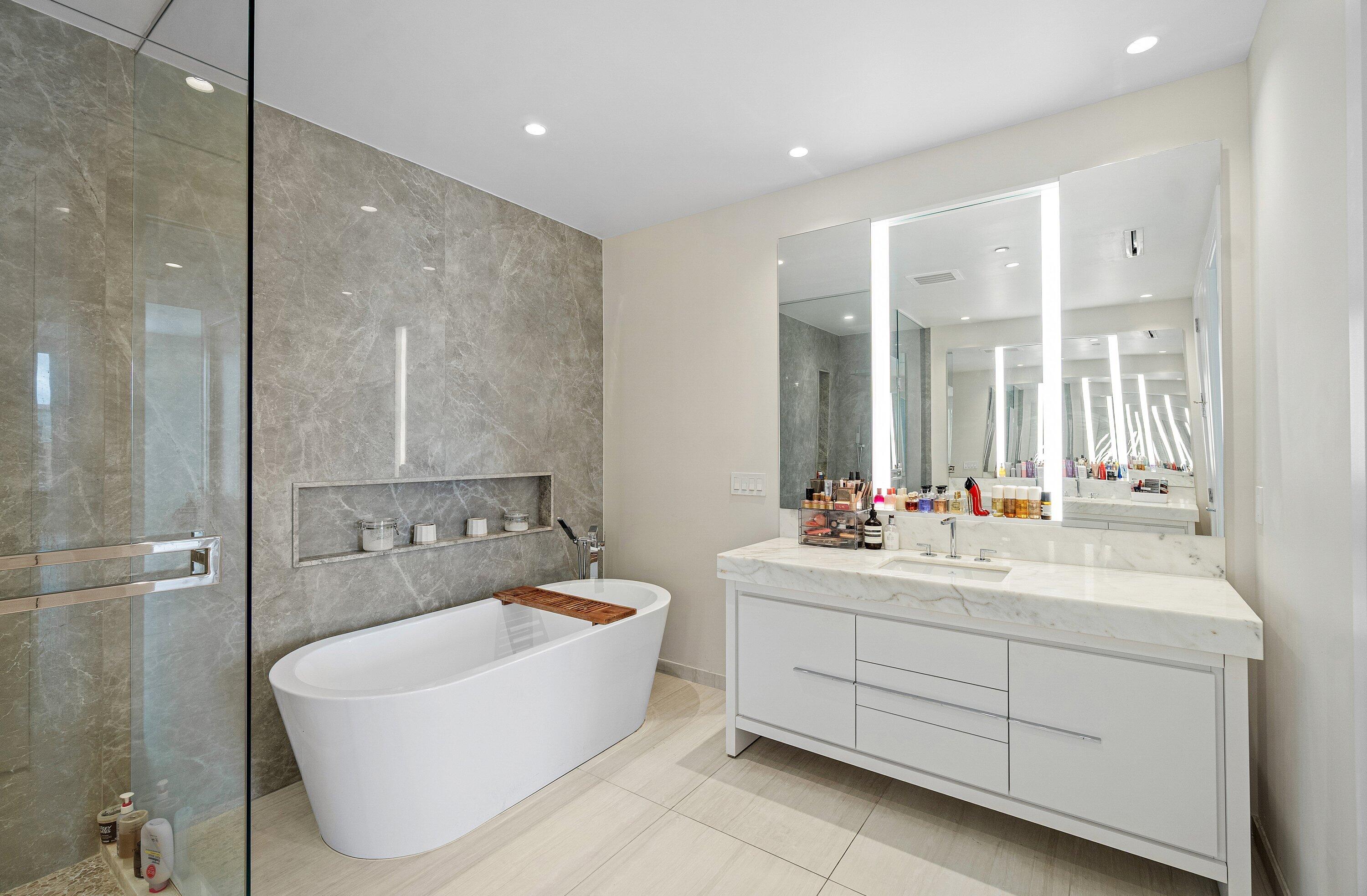 200 Southeast Mizner Boulevard, Unit 810 Boca Raton, FL 33432 - Photo 18 of 29 a bathroom with a double vanity sink mirror and bathtub