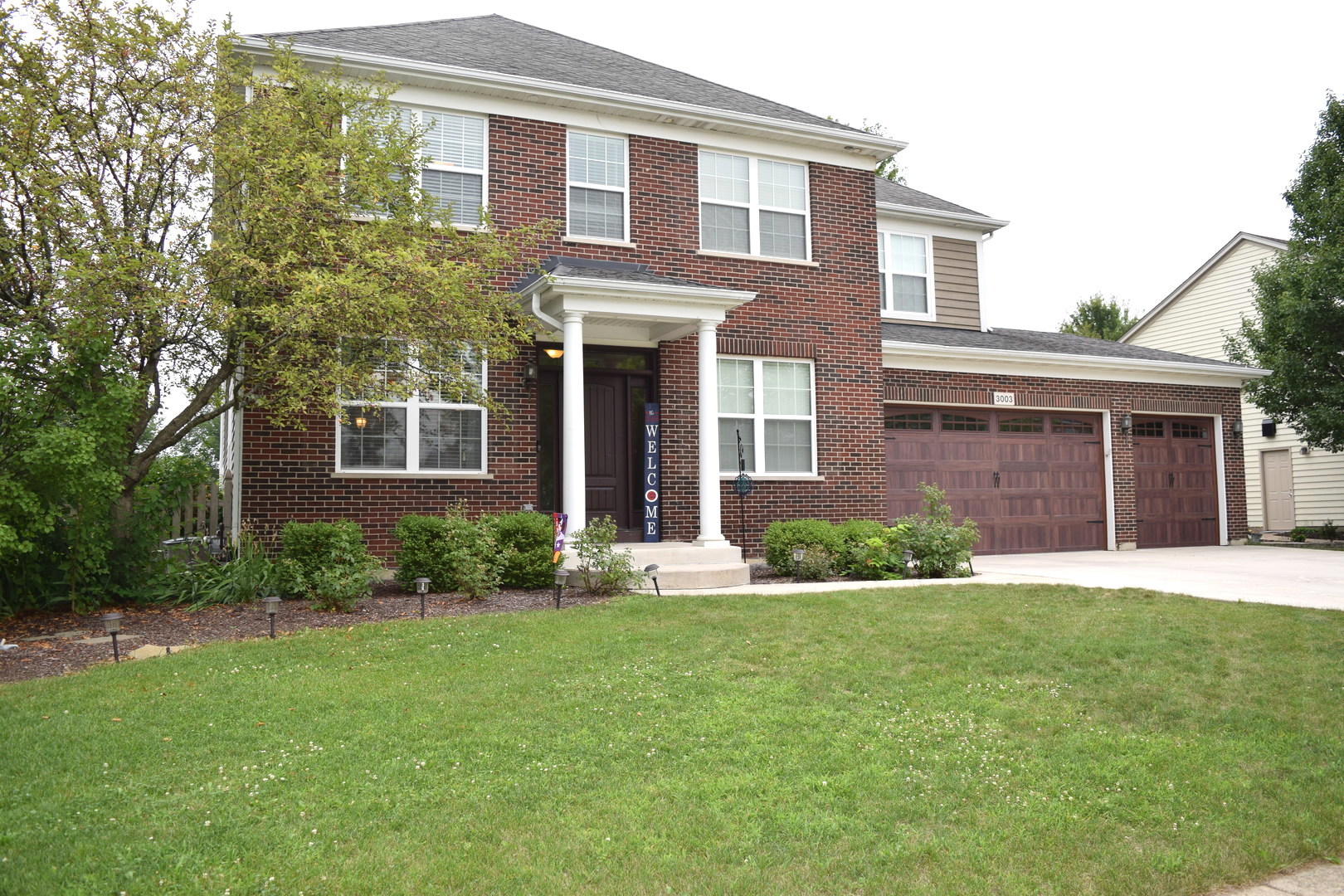 3003 Wayland Avenue Elgin, IL 60124 - Photo 1 of 32 a front view of a house with a yard and garage