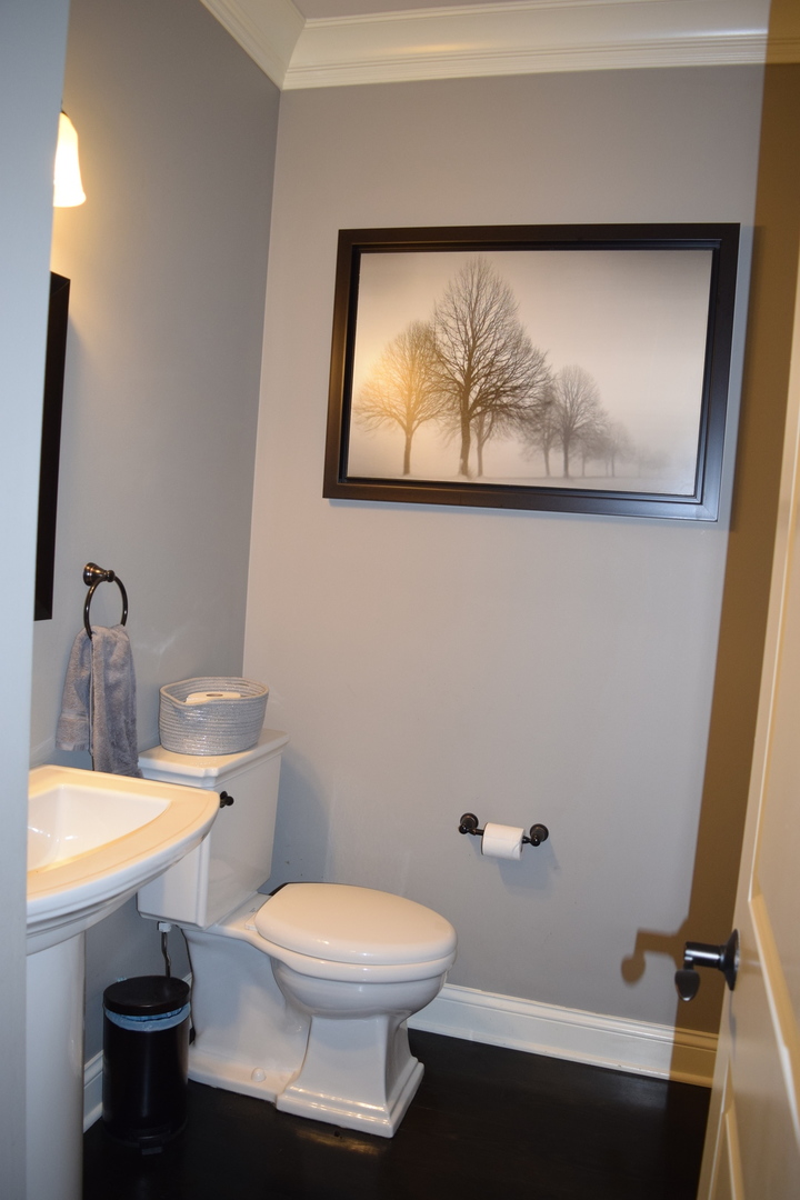 3003 Wayland Avenue Elgin, IL 60124 - Photo 11 of 32 a bathroom with a toilet a sink and mirror