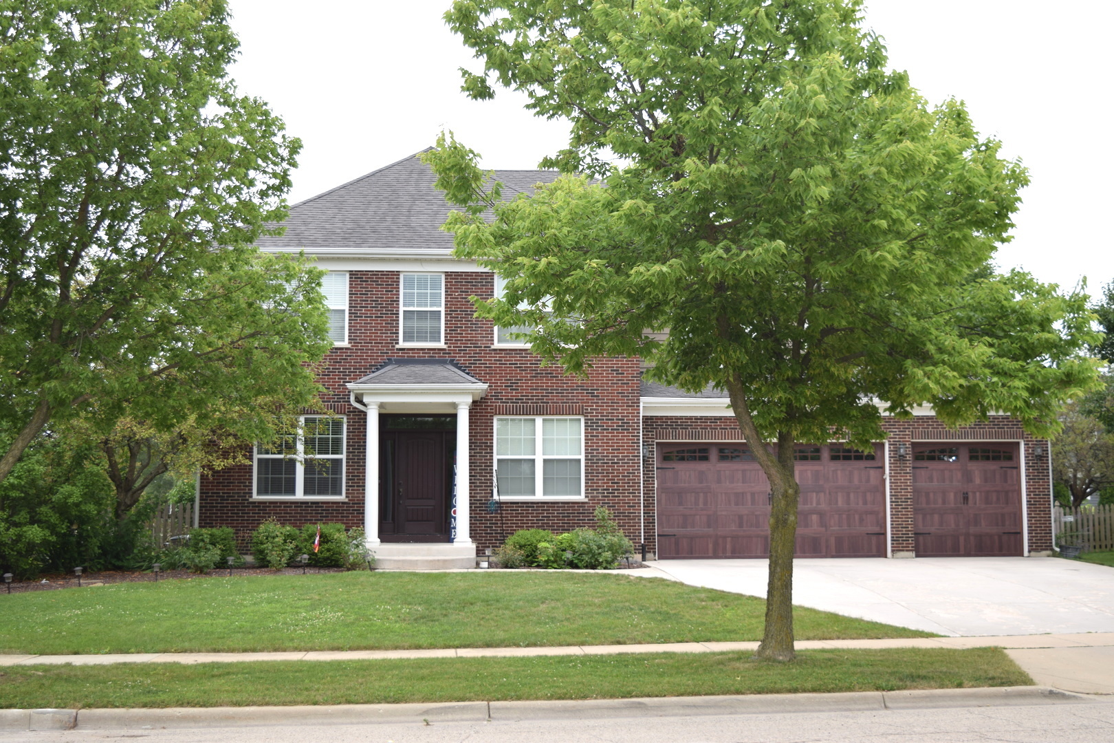 3003 Wayland Avenue Elgin, IL 60124 - Photo 2 of 32 a front view of a house with a garden