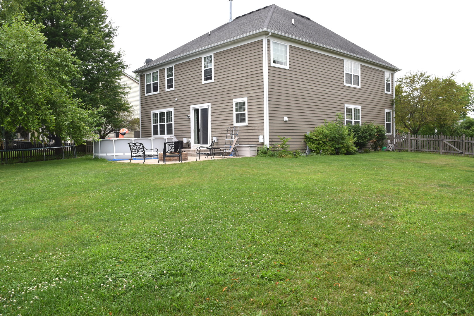 3003 Wayland Avenue Elgin, IL 60124 - Photo 30 of 32 a front view of a house with a garden and patio