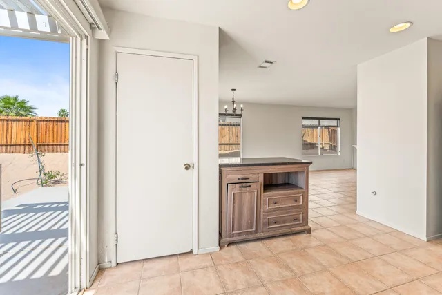 a view of kitchen with stainless steel appliances granite countertop a refrigerator and a stove top oven