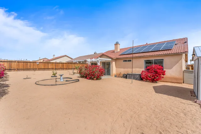 front view of a house with table and chairs
