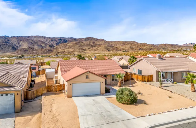 a view of multiple houses with a yard