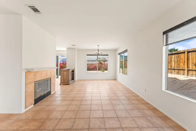 a view of a electric appliances in kitchen and empty room with windows