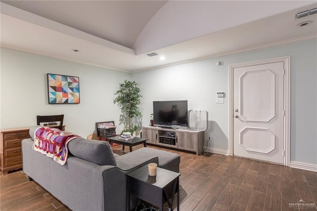 1902 Sundance Street Palmhurst, TX 78573 - Photo 17 of 43 a living room with furniture a flat screen tv and a window