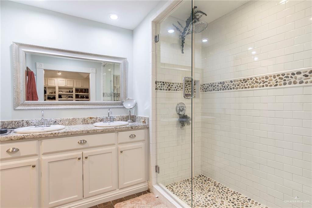 1902 Sundance Street Palmhurst, TX 78573 - Photo 20 of 43 a bathroom with a shower sink and mirror