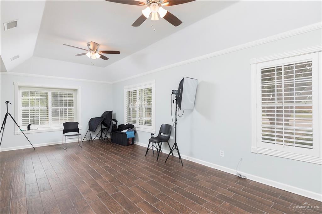 1902 Sundance Street Palmhurst, TX 78573 - Photo 28 of 43 a view of a livingroom with furniture hardwood floor a ceiling fan and windows