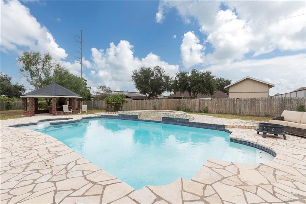 1902 Sundance Street Palmhurst, TX 78573 - Photo 34 of 43 a view of a swimming pool with lounge chairs in patio