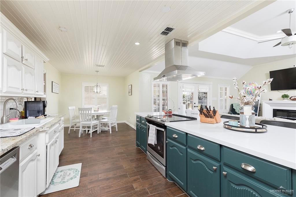 1902 Sundance Street Palmhurst, TX 78573 - Photo 9 of 43 a large kitchen with lots of counter a sink and cabinets