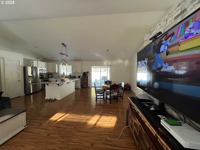 a living room with lots of furniture and kitchen view
