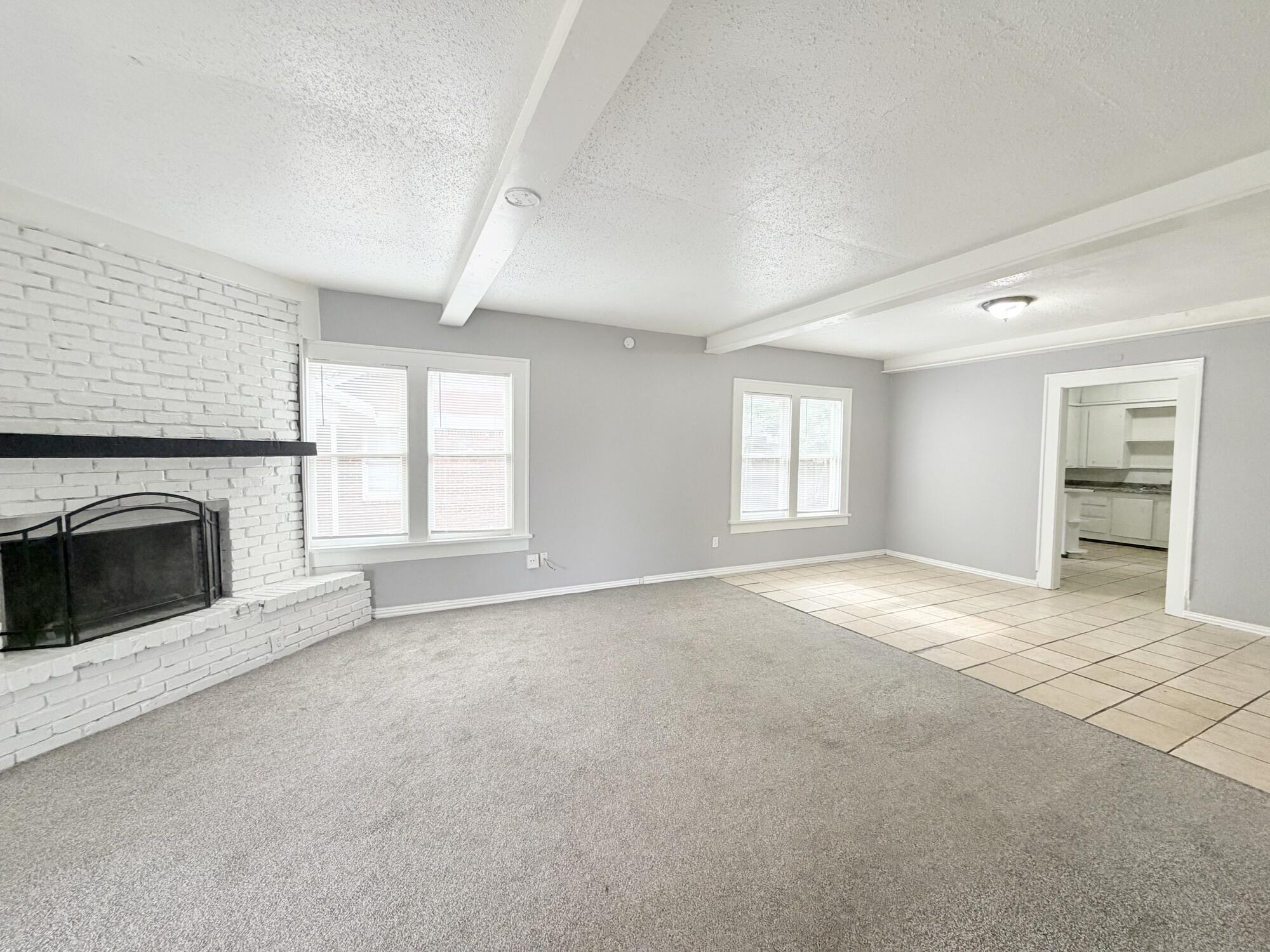 2119 15th Street Lubbock, TX 79401 - Photo 3 of 15 a view of empty room with a fireplace