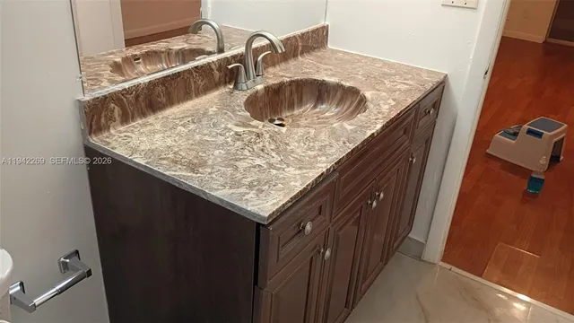 a kitchen with a sink and cabinets
