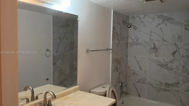 a bathroom with a sink and shower
