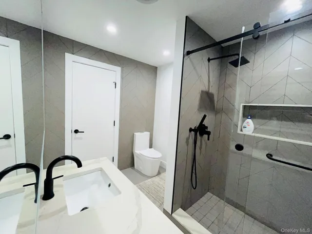 a bathroom with a toilet sink and shower