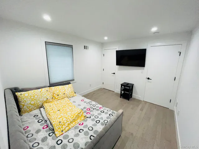 a bedroom with a bed and flat screen tv