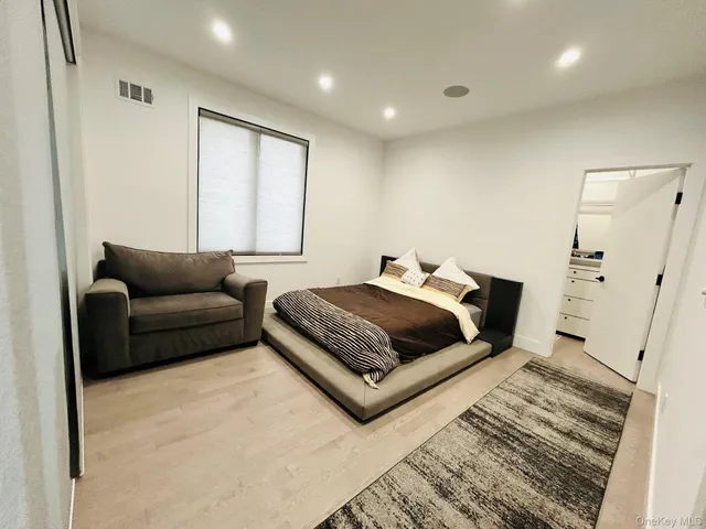 a bedroom with a bed couch and window