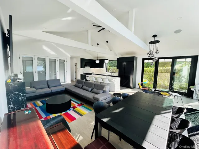 a living room with furniture and large pool table