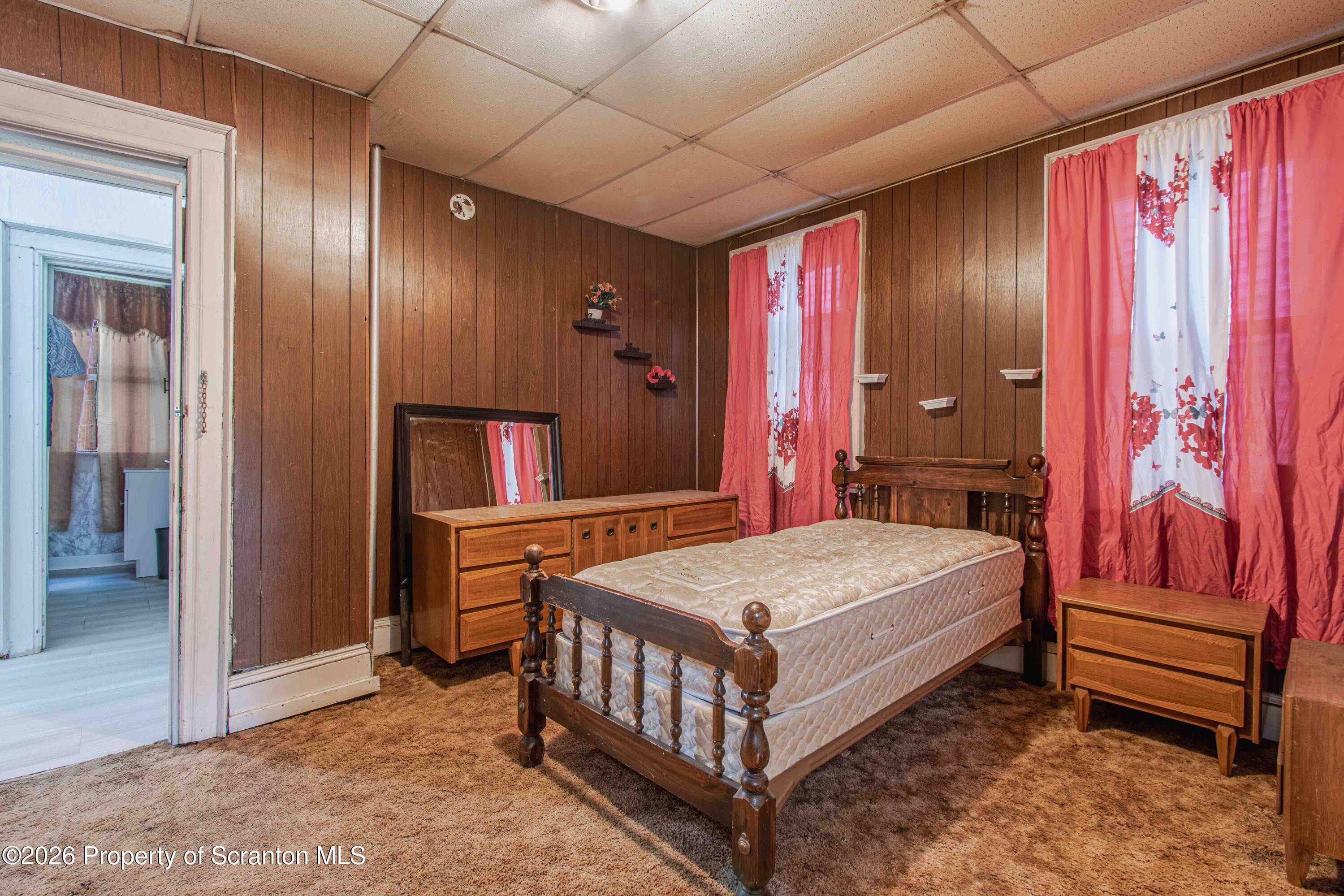 844 Monroe Avenue, Unit 844 Scranton, PA 18510 - Photo 14 of 15 a bedroom with a bed and a chandelier