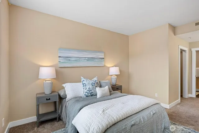 a bedroom with a bed and a night stand