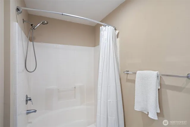 a bathroom with a shower and a tub