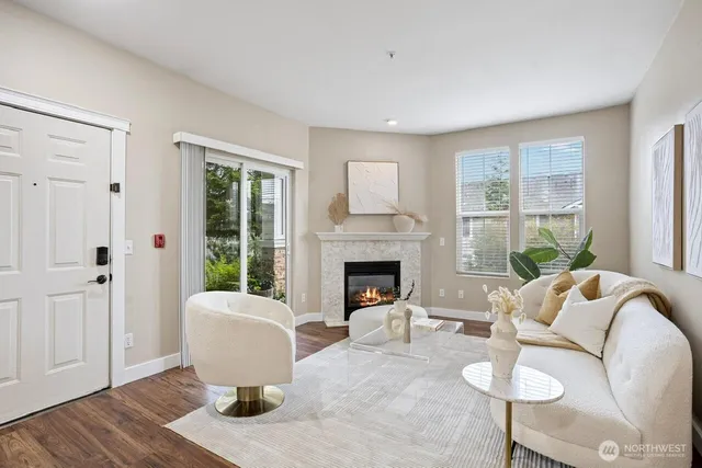 a living room with furniture a large window and a fireplace