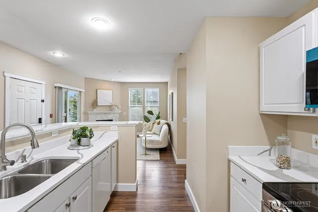 a en suite bathroom with a granite countertop sink and mirror