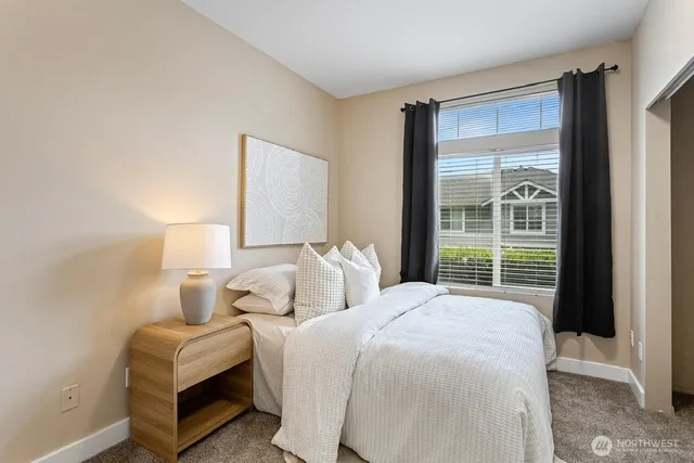 a bedroom with two beds and a large window
