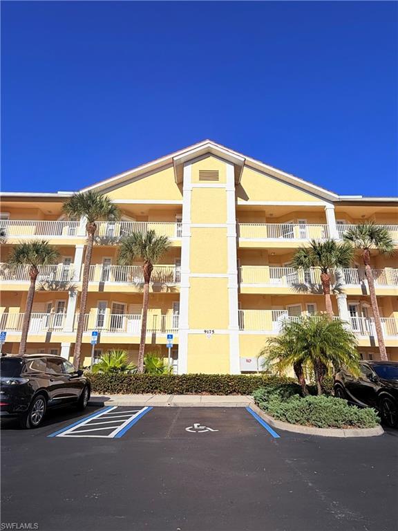 9175 Celeste Drive, Unit 2 Naples, FL 34113 - Photo 1 of 13 a view of a city street with tall buildings