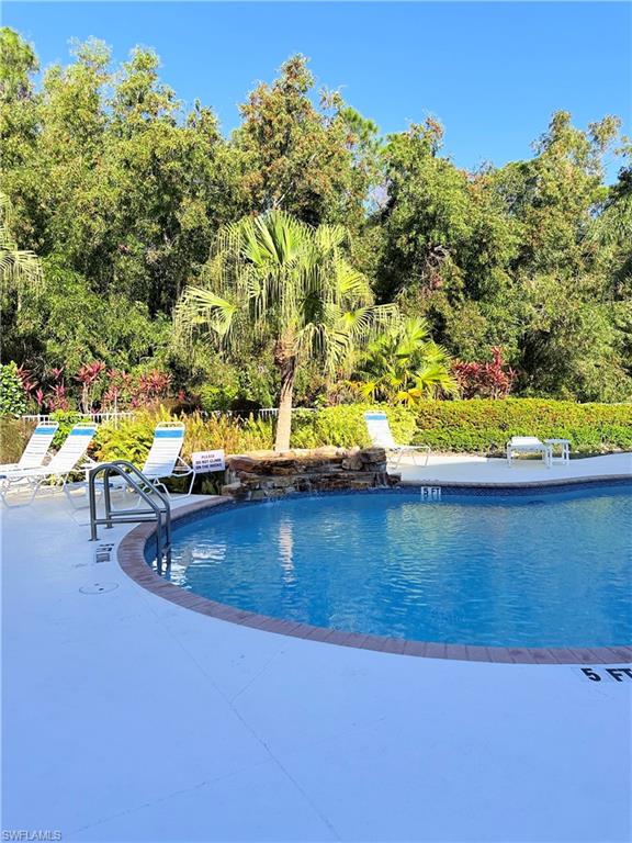 9175 Celeste Drive, Unit 2 Naples, FL 34113 - Photo 12 of 13 a view of swimming pool with a yard
