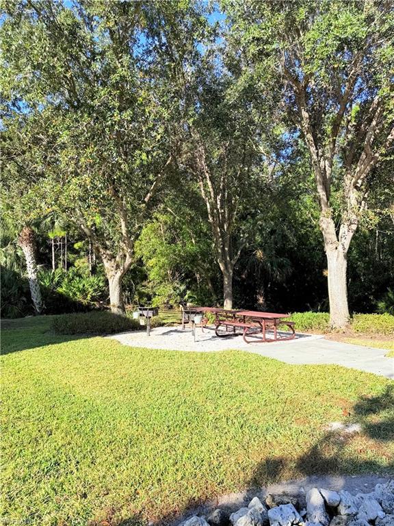 9175 Celeste Drive, Unit 2 Naples, FL 34113 - Photo 13 of 13 a view of a swimming pool and an outdoor space