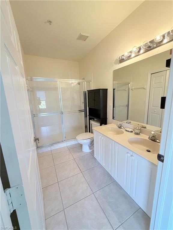 9175 Celeste Drive, Unit 2 Naples, FL 34113 - Photo 3 of 13 a bathroom with a tub sink and mirror