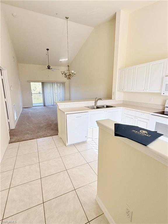 9175 Celeste Drive, Unit 2 Naples, FL 34113 - Photo 9 of 13 a kitchen with a sink a counter and cabinets