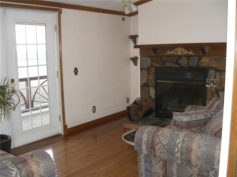 268 Chestnut Ridge Road Washington, PA 15301 - Photo 15 of 24 The den off the kitchen opens to the wrap around porch and boasts a log burning fireplace