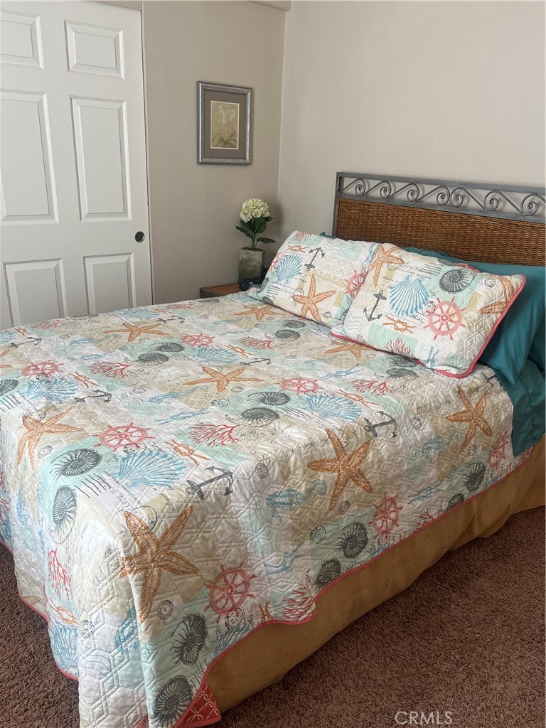 1189 Marina Drive Needles, CA 92363 - Photo 17 of 26 a bedroom with a bed and a painting on the wall