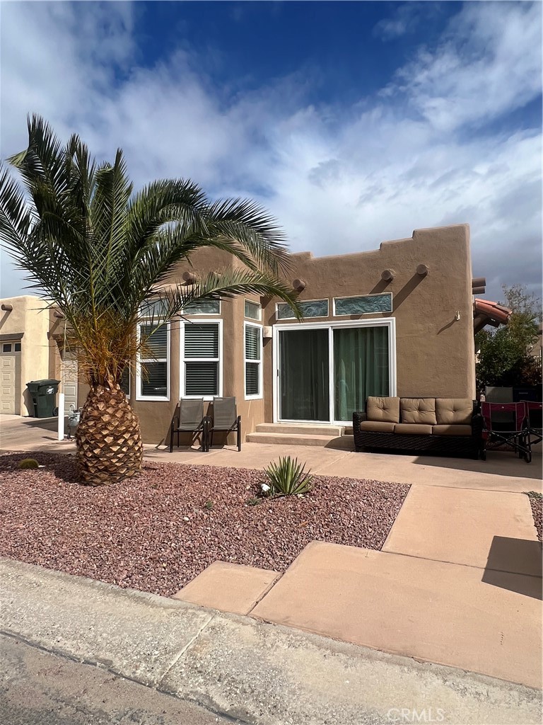 1189 Marina Drive Needles, CA 92363 - Photo 2 of 26 front view of a house with a yard and many windows