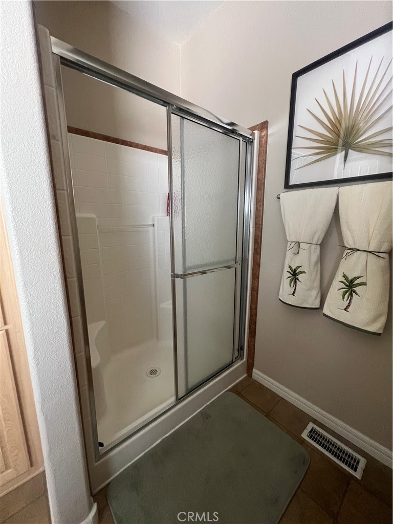 1189 Marina Drive Needles, CA 92363 - Photo 21 of 26 a bathroom with a glass shower door